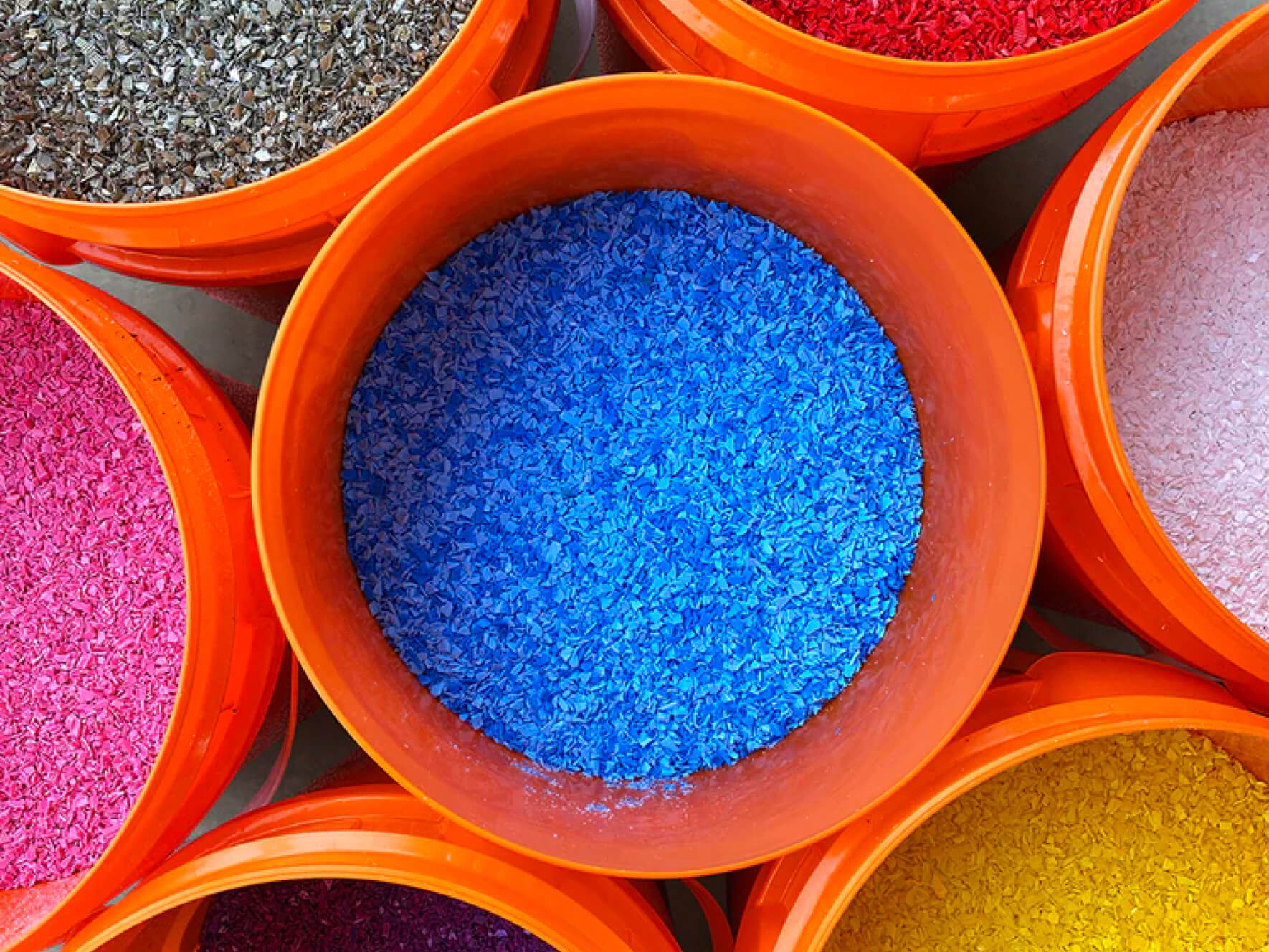 Buckets full of recycled plastic flakes.