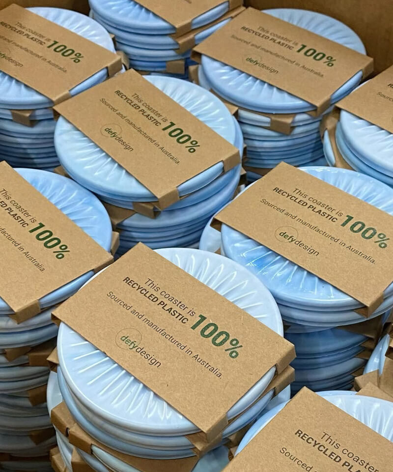 Round ribbed coasters made from 100% recycled plastic.