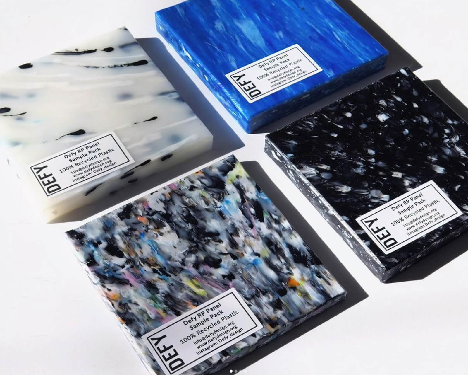 Multicoloured square samples of recycled plastic.