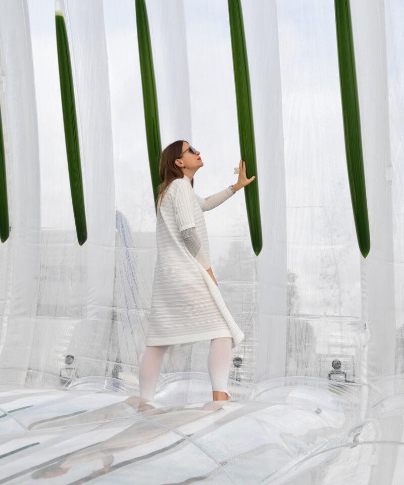Woman holding a purifier inside the AirBubble eco-machine.