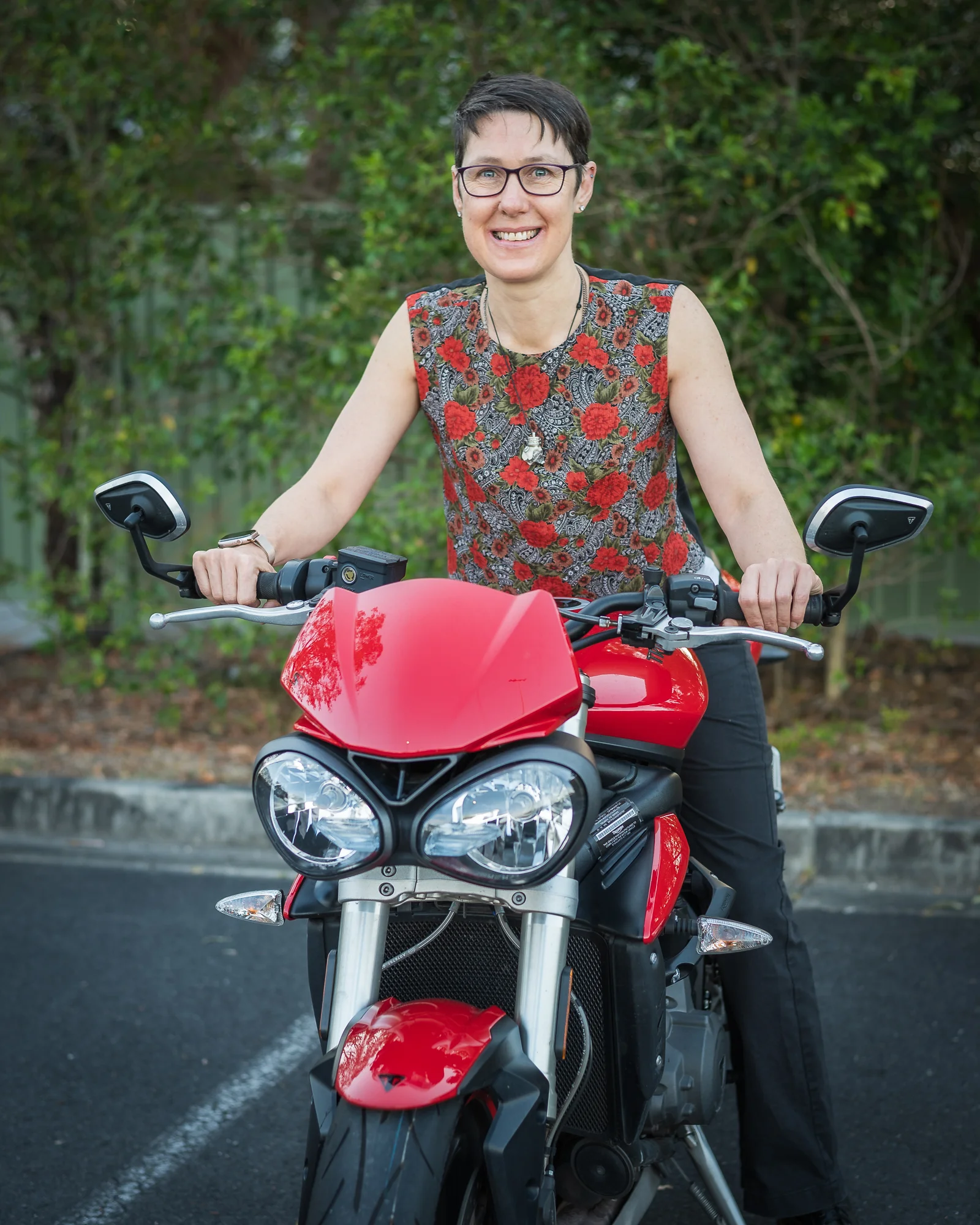 Cath sitting on her motorcycle front