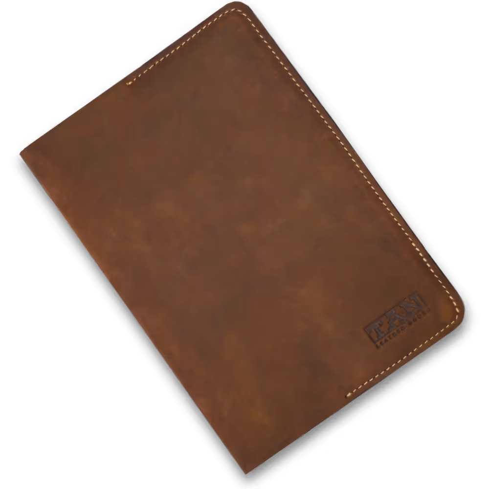 Closed brown leather notebook with visible stitching and an embossed logo in the bottom right corner.