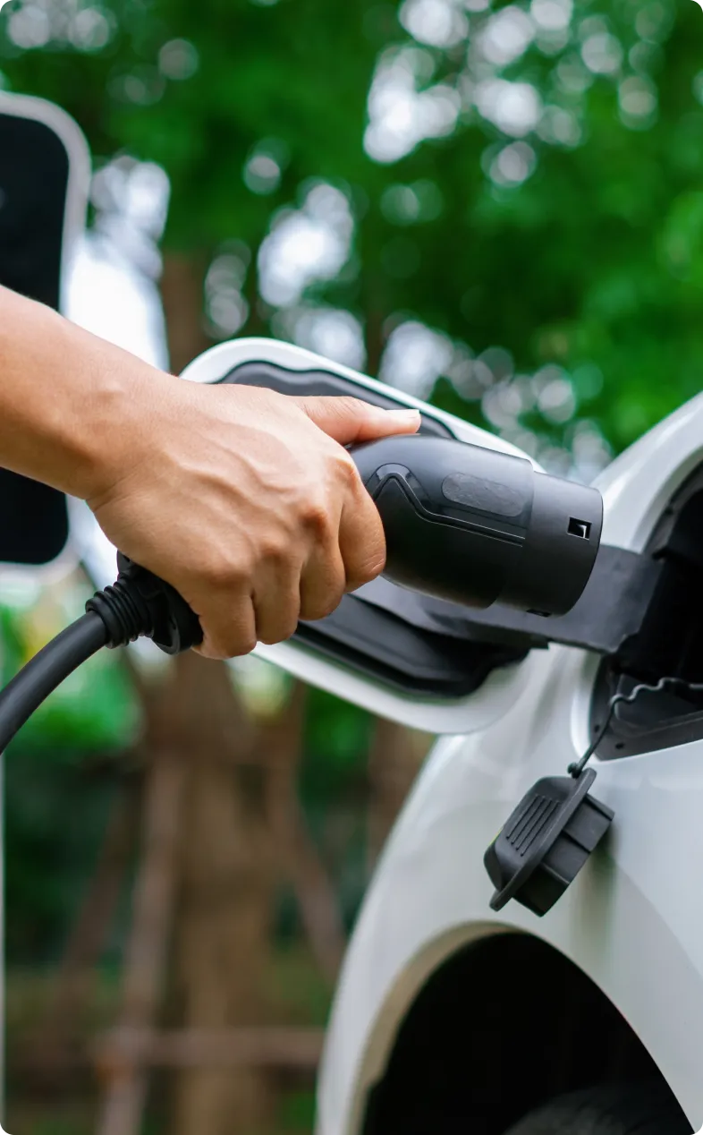 Close-up of a hand holding EV charger plug