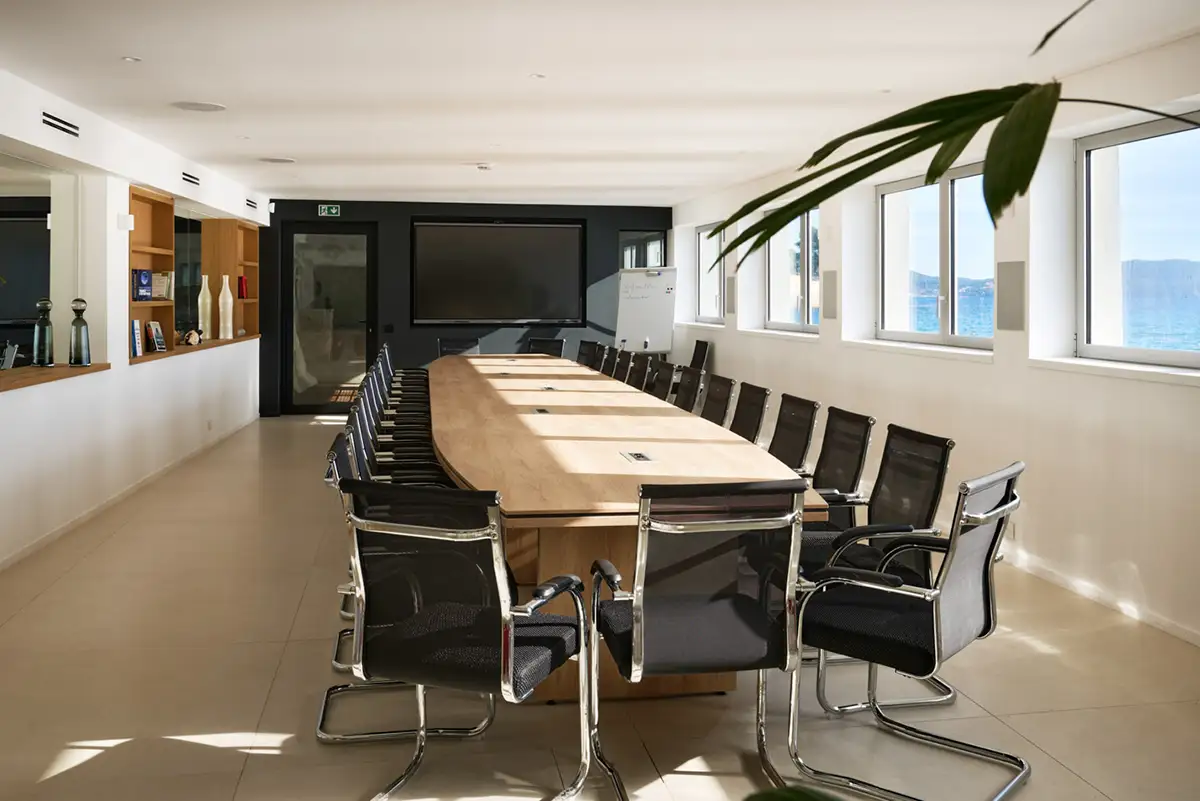 Salle de conférence lumineuse avec grande table professionnelle et vue mer – business center high-tech de La Villa L’Île Verte