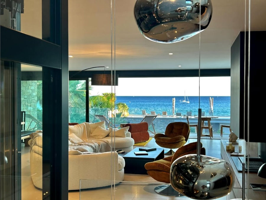 Lustre design suspendu dans le salon premier étage de la Villa L'Île Verte, vue sur la mer en arrière-plan, La Ciotat