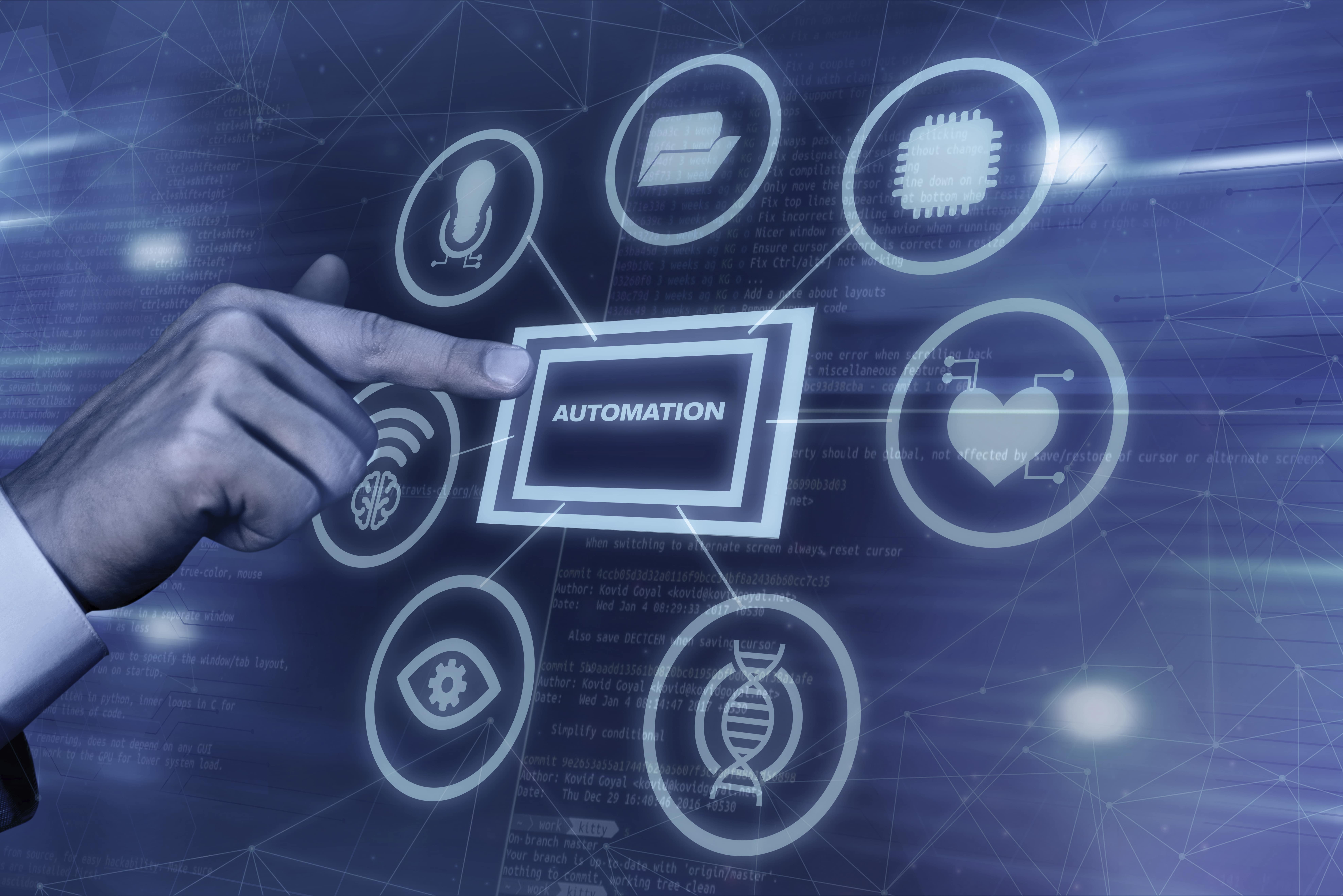 Hand pointing at digital interface with central 'AUTOMATION' label connected to icons representing technology concepts.