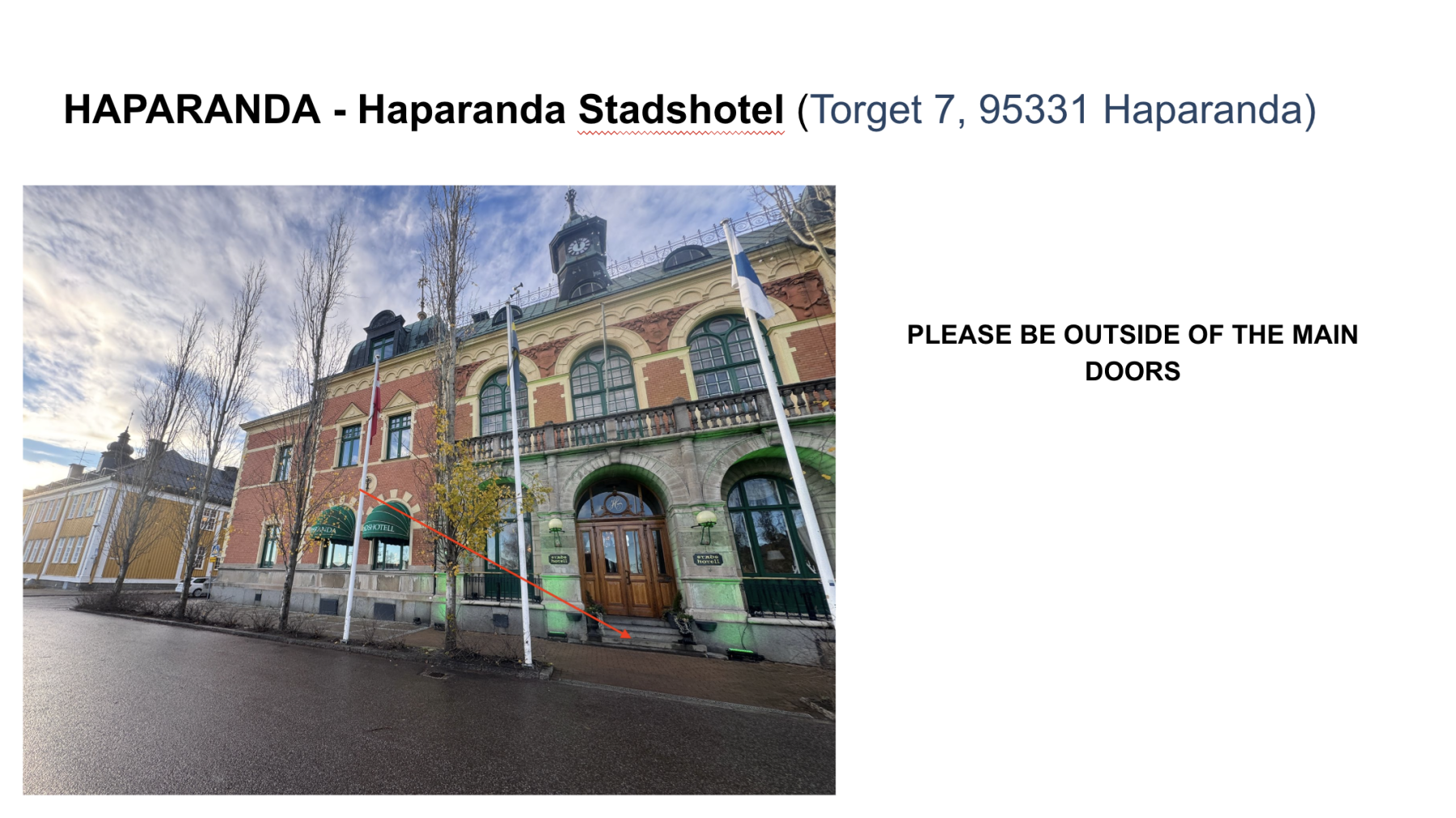 Exterior of Haparanda Stadshotel, a historic building with brick and stone facade, green awnings, flagpoles, and a clock tower under a cloudy sky.