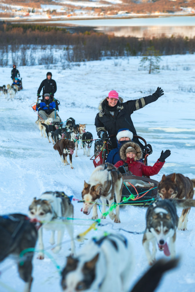 Tourists having fun on a dog sled ride at the Tromso Wilderness Centre