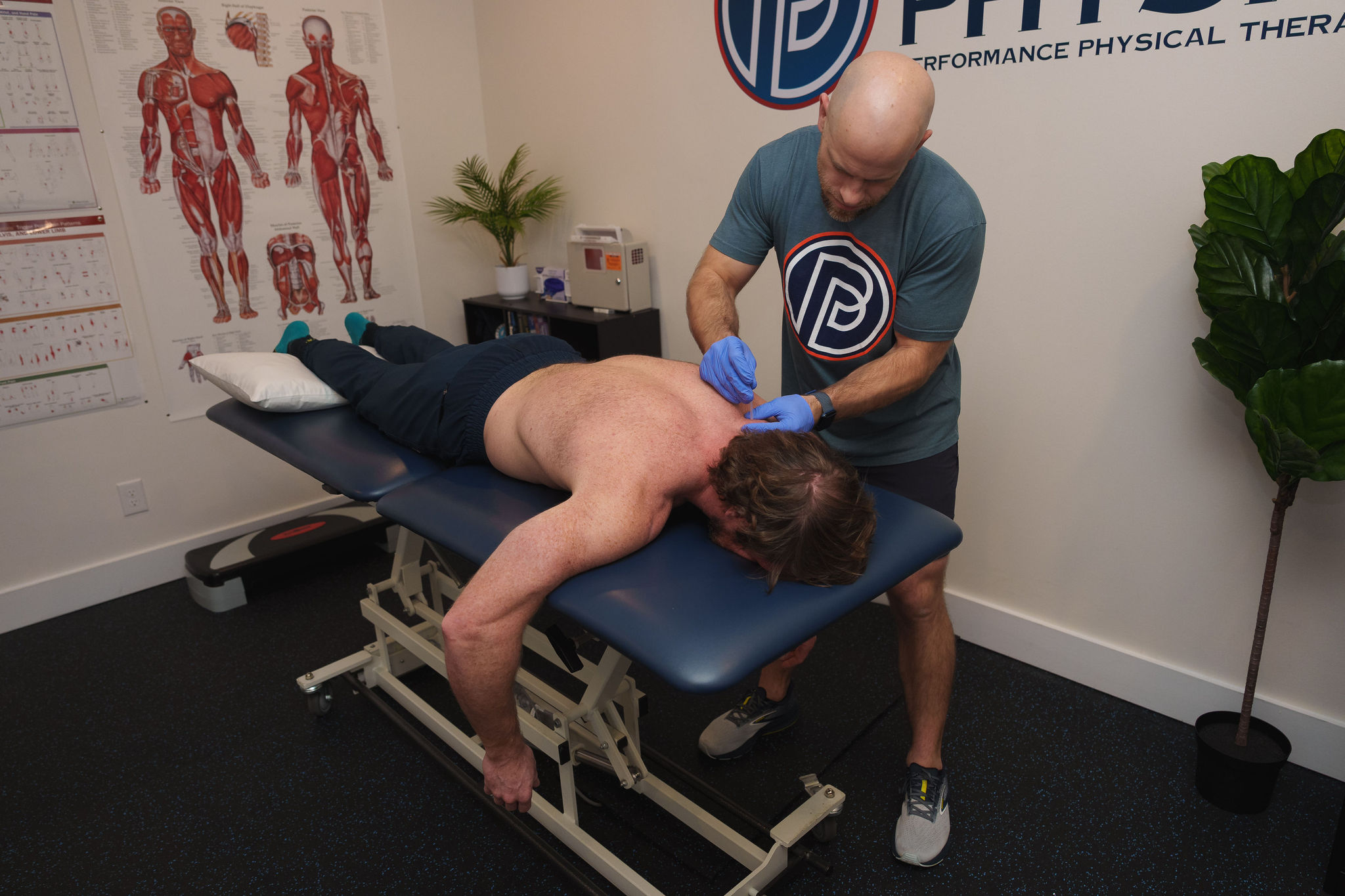 athlete working one-on-one with a physical therapist during a performance-focused rehabilitation session