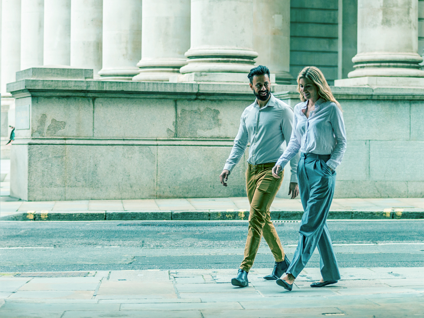 Male and female City workers  walking in London.