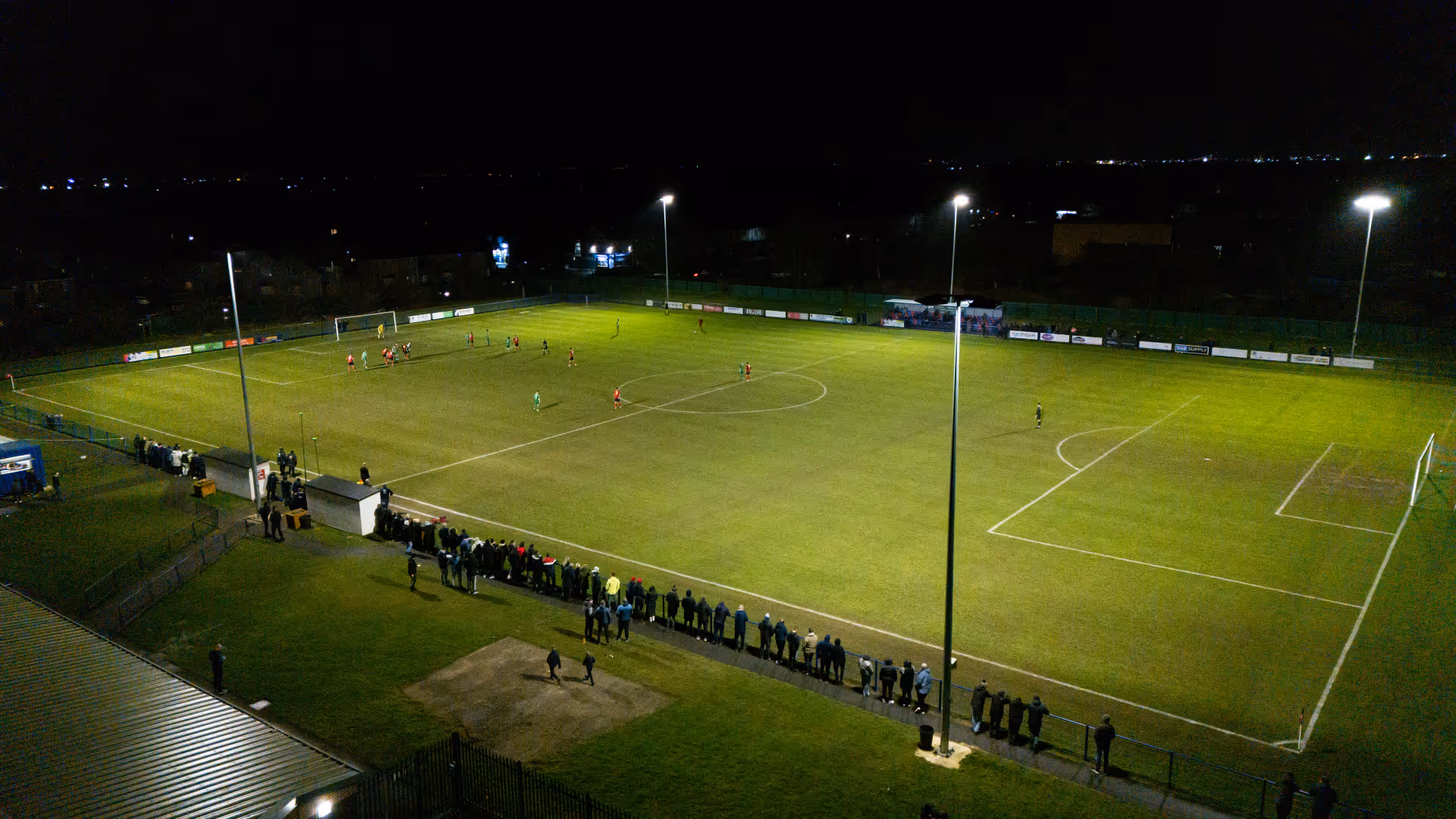Aerial image of FC Hartlepool's pitch which is lit up by floodlights and surrounded by a crowd.