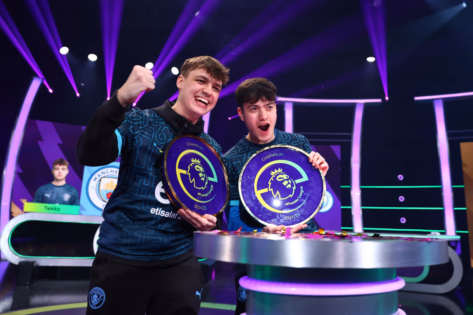 ePremier League winners from Manchester City celebrate with their circular trophies.