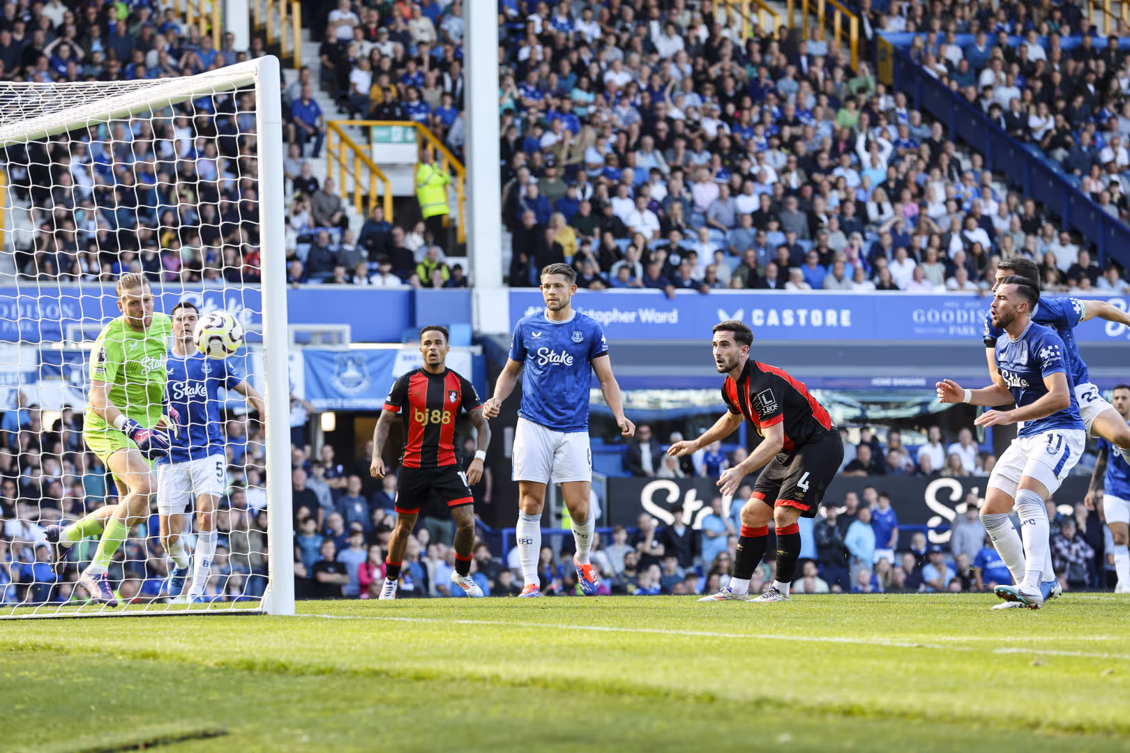 Everton and Bournemouth players watch as the ball goes past Jordan Pickford.
