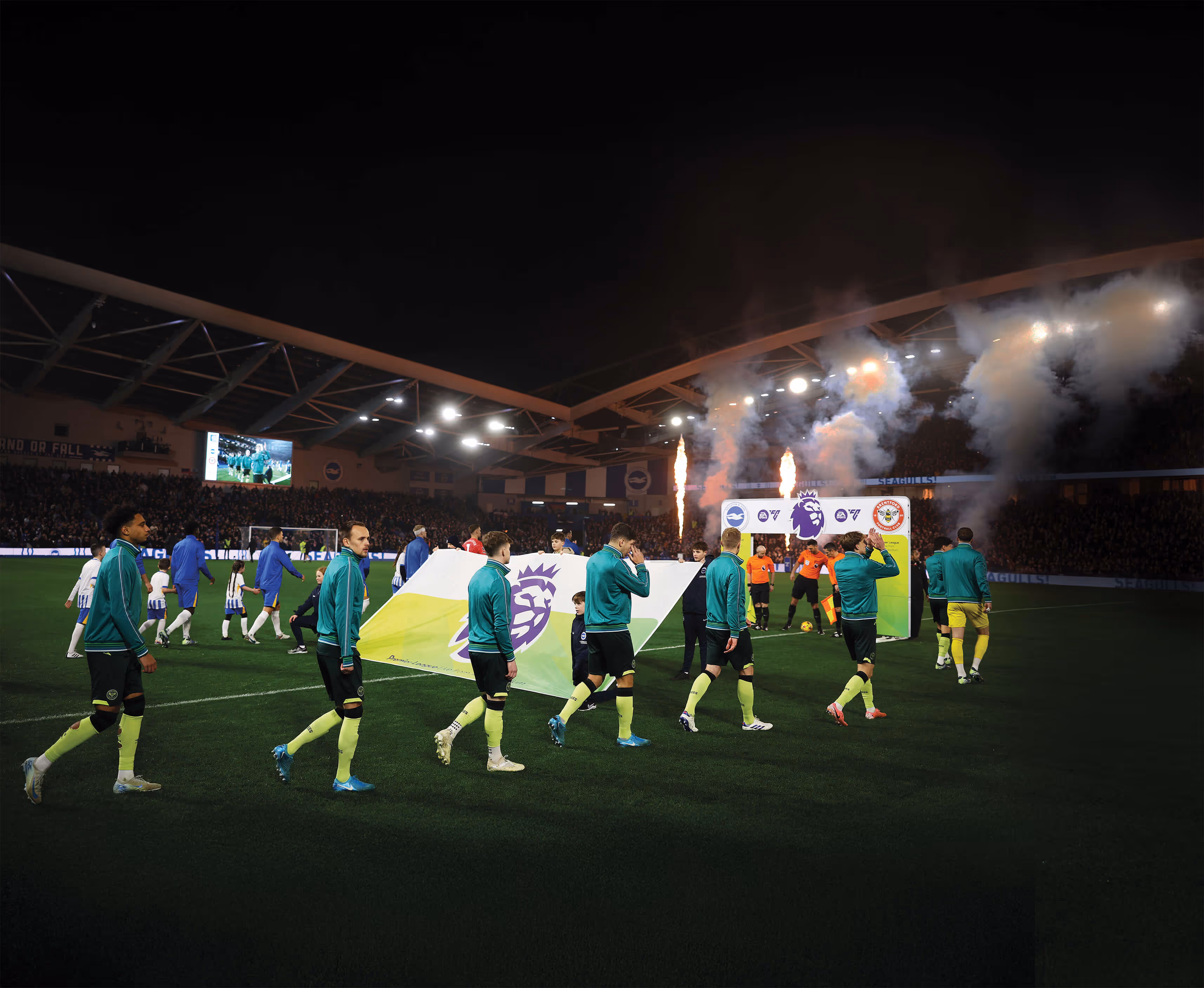 Brentford players walk-out pre-match at Brighton & Hove Albion's Amex Stadium.