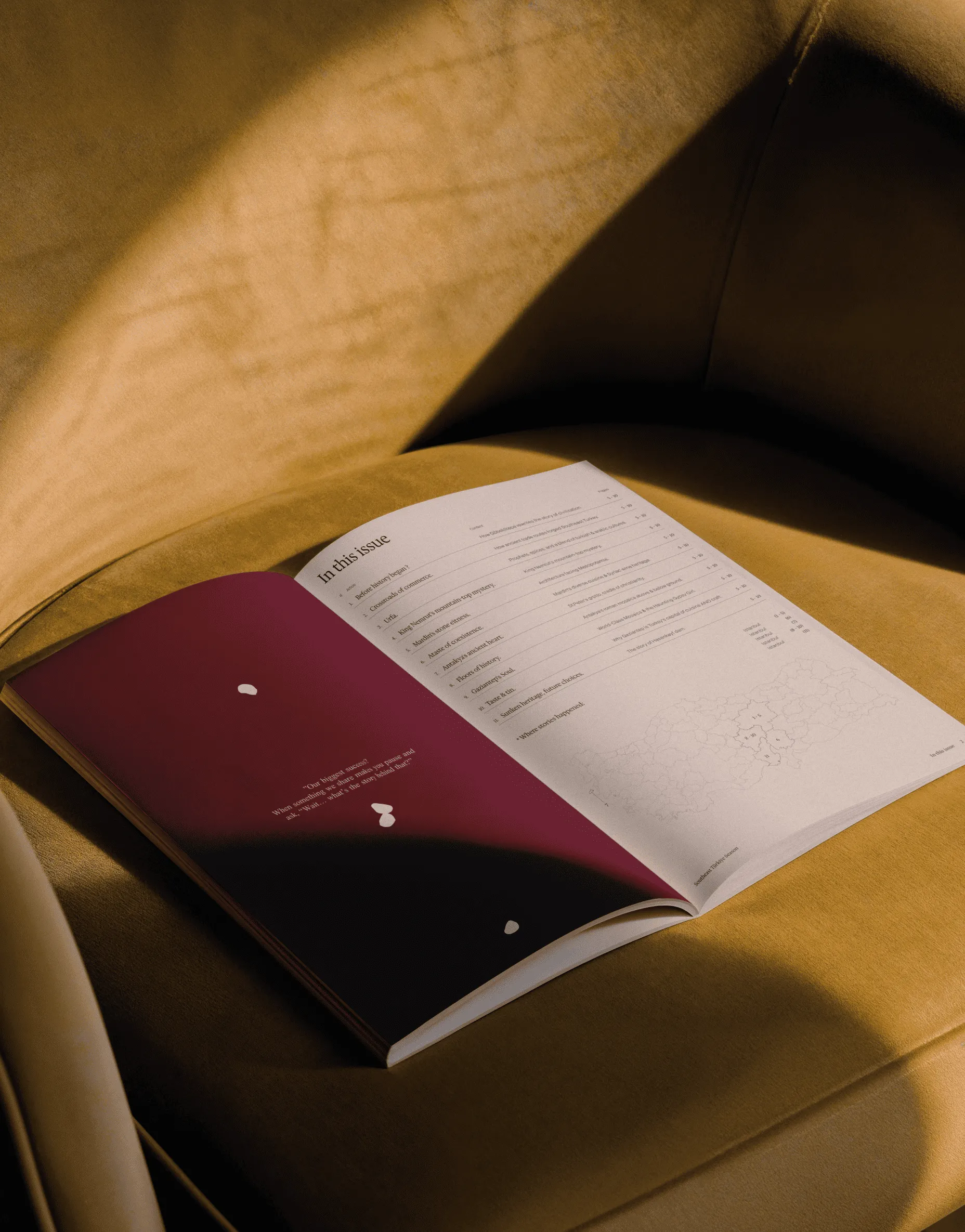 Open book spread with burgundy pages and editorial layout.