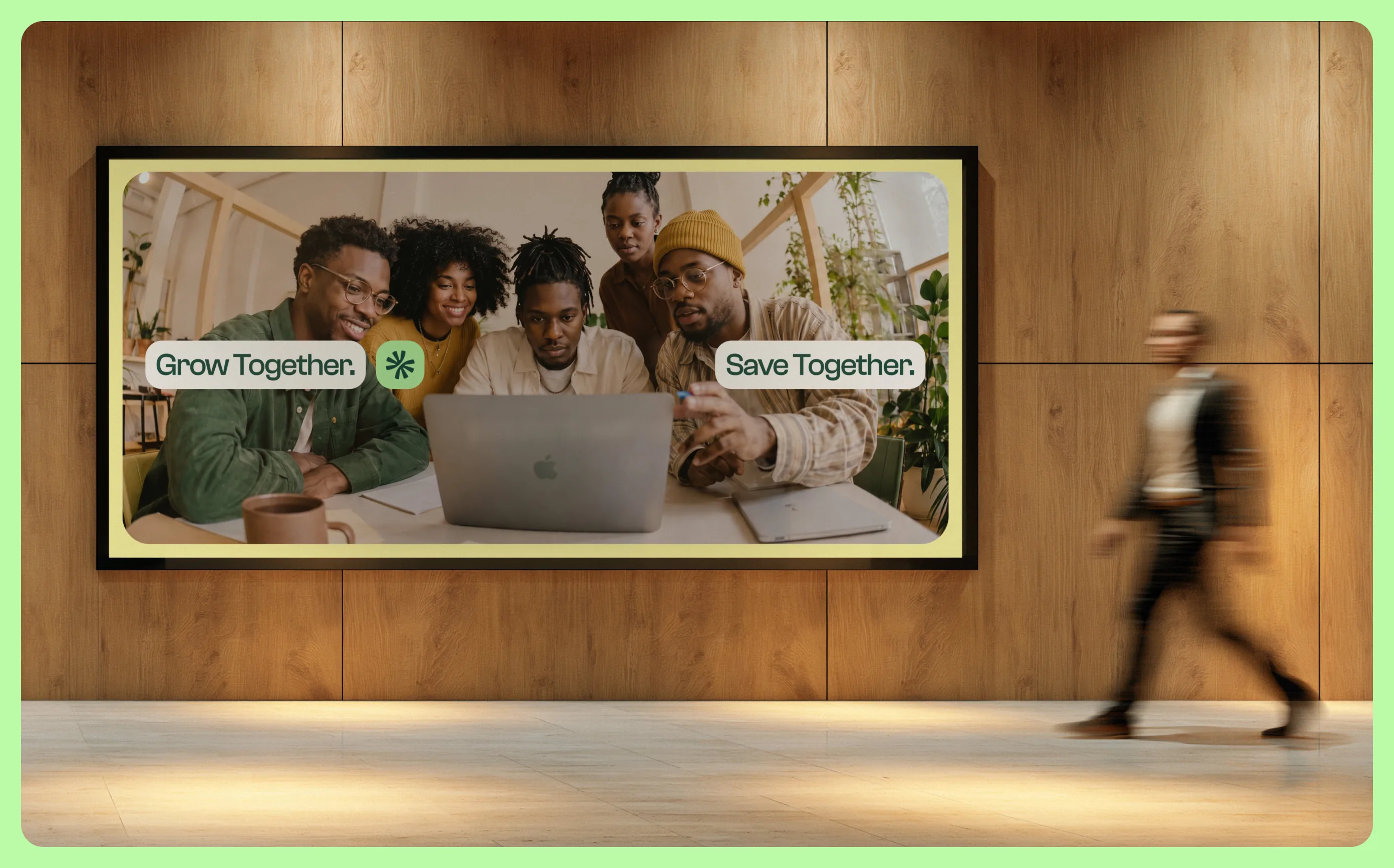 Faïda campaign on a wall-mounted screen: Grow Together, Save Together