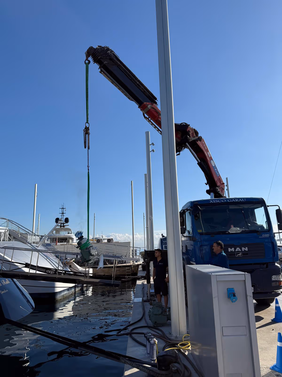 crane lifting advanced marine material onto a boat