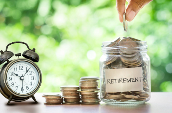 Retirement Fund | Putting Quarters In A Jar Next To An Alarm Clock