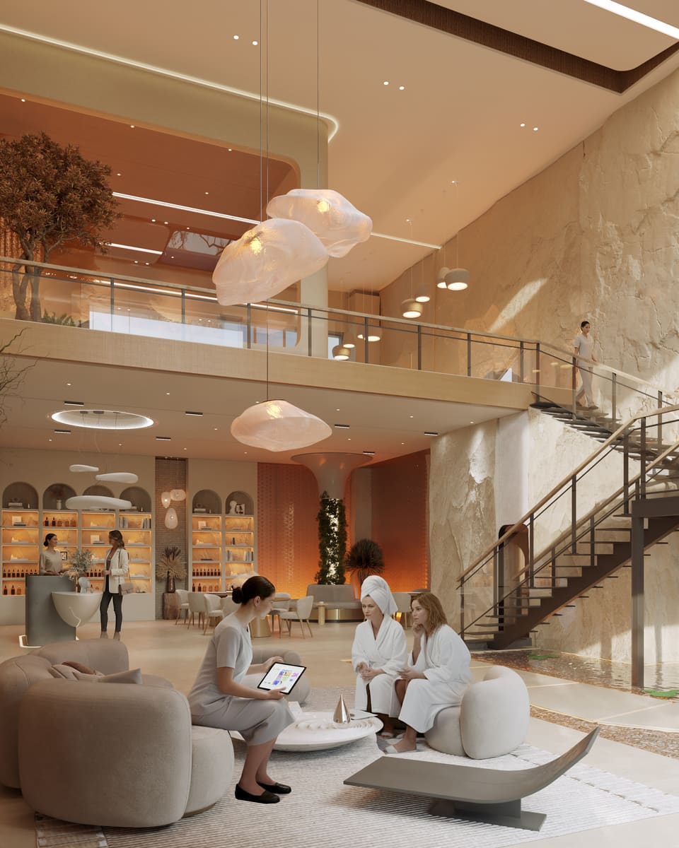 A warm-lit spa reception with a mezzanine above.
