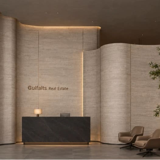 A reception lobby with curved stone walls and a dark stone desk.