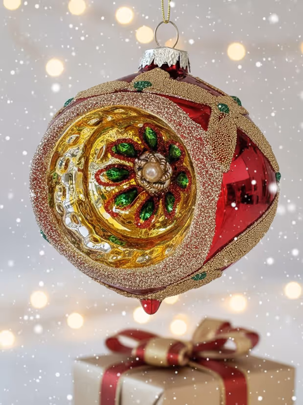 Decorative red and gold Christmas ornament with green accents.