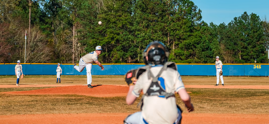 Cary Academy middle school baseball team in action during a home game on the athletic field.