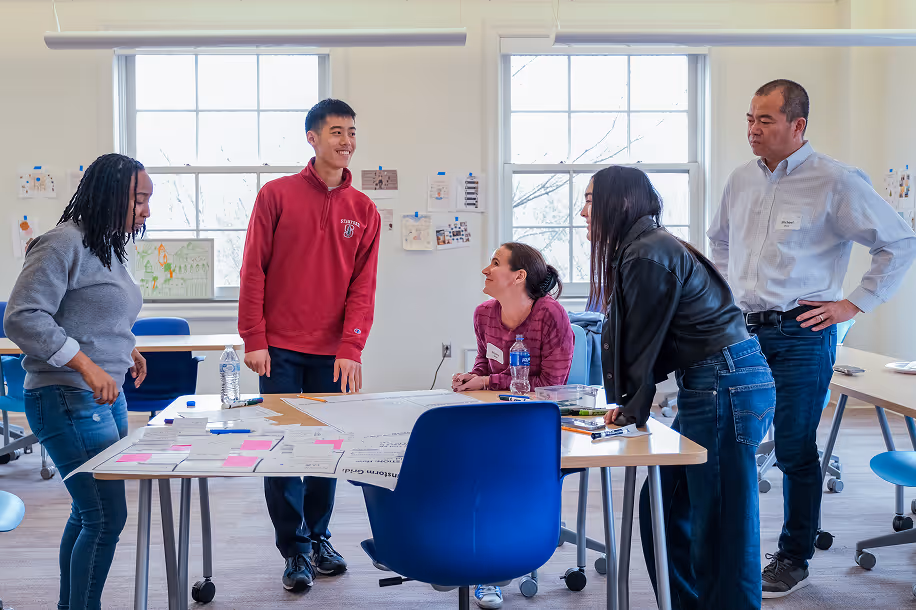 Cary Academy faculty, students, and parents collaborating in workshop session during strategic planning meeting.