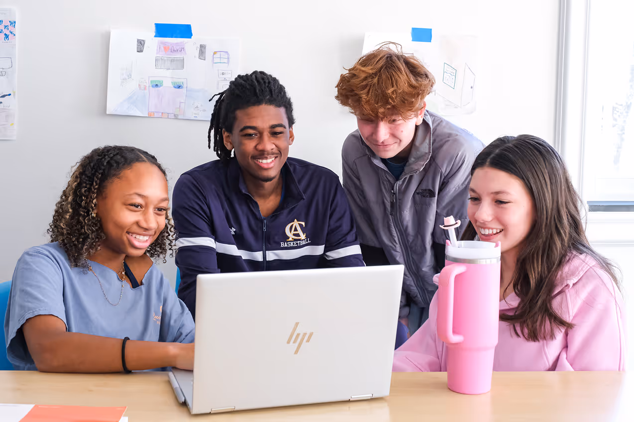 Middle school students collaborating on laptop during Cary Academy Anti-Racist Day classroom activity.