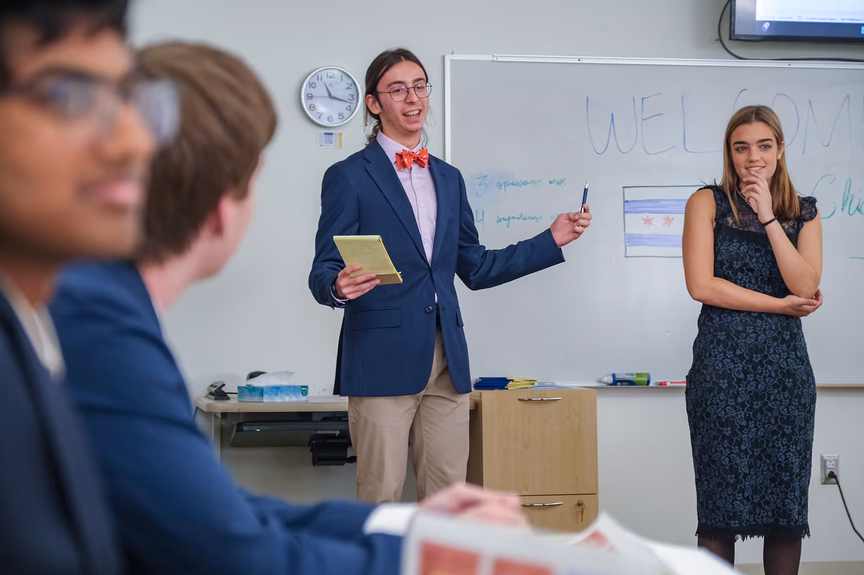 Cary Academy students leading a Model UN conference presentation in a classroom setting.