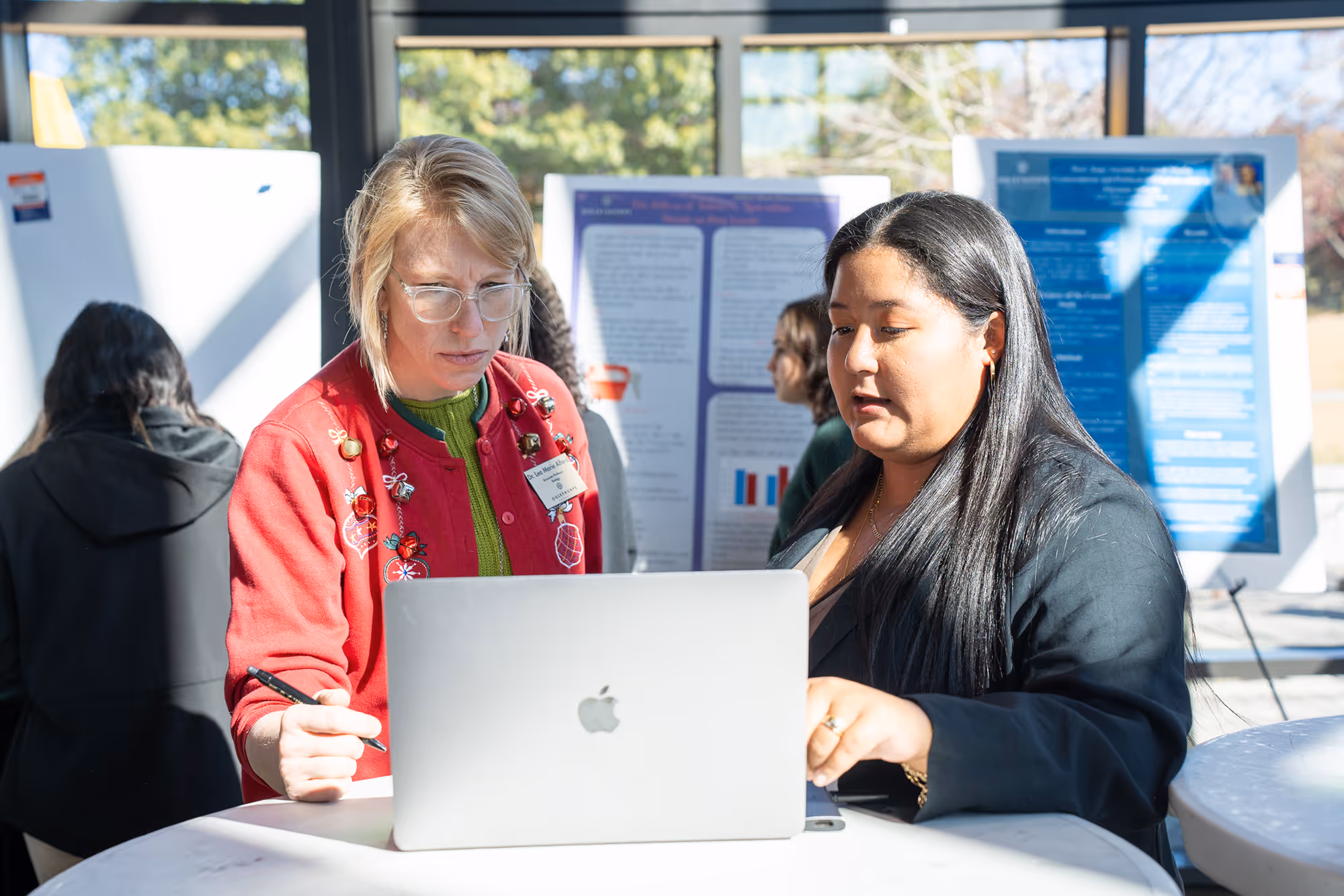 Faculty and a student collaborate on a project.