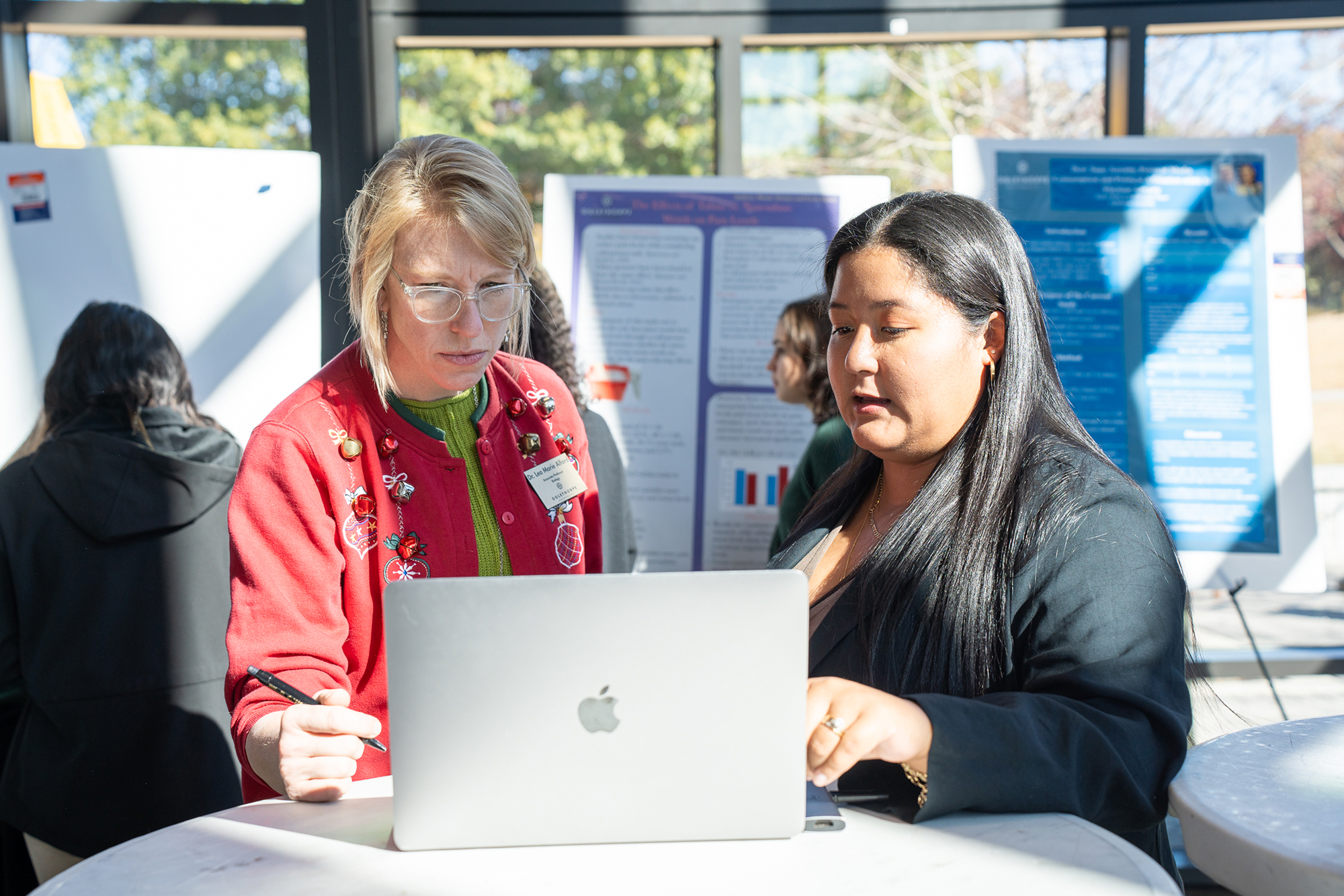 Faculty and a student collaborate on a project.