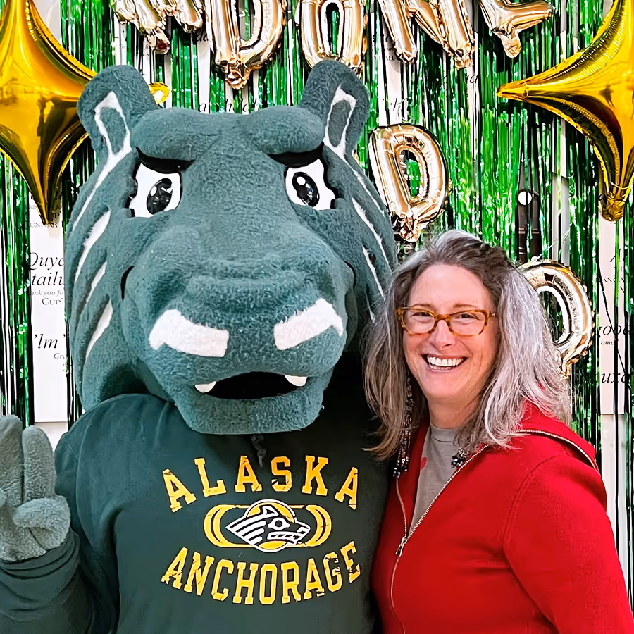 Portrait photo of staff member with college mascot