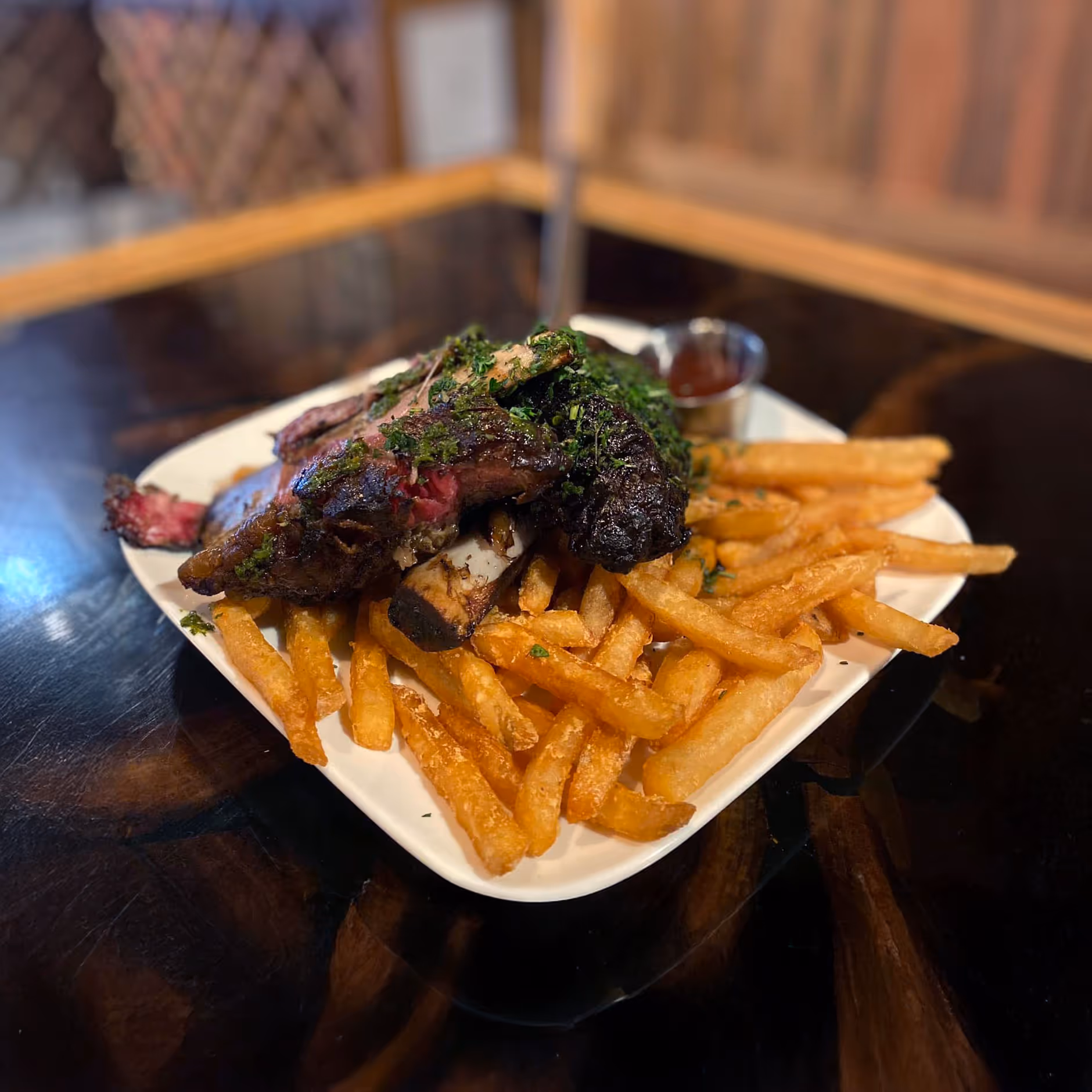 A plate of beef ribs accompanied by French fries.