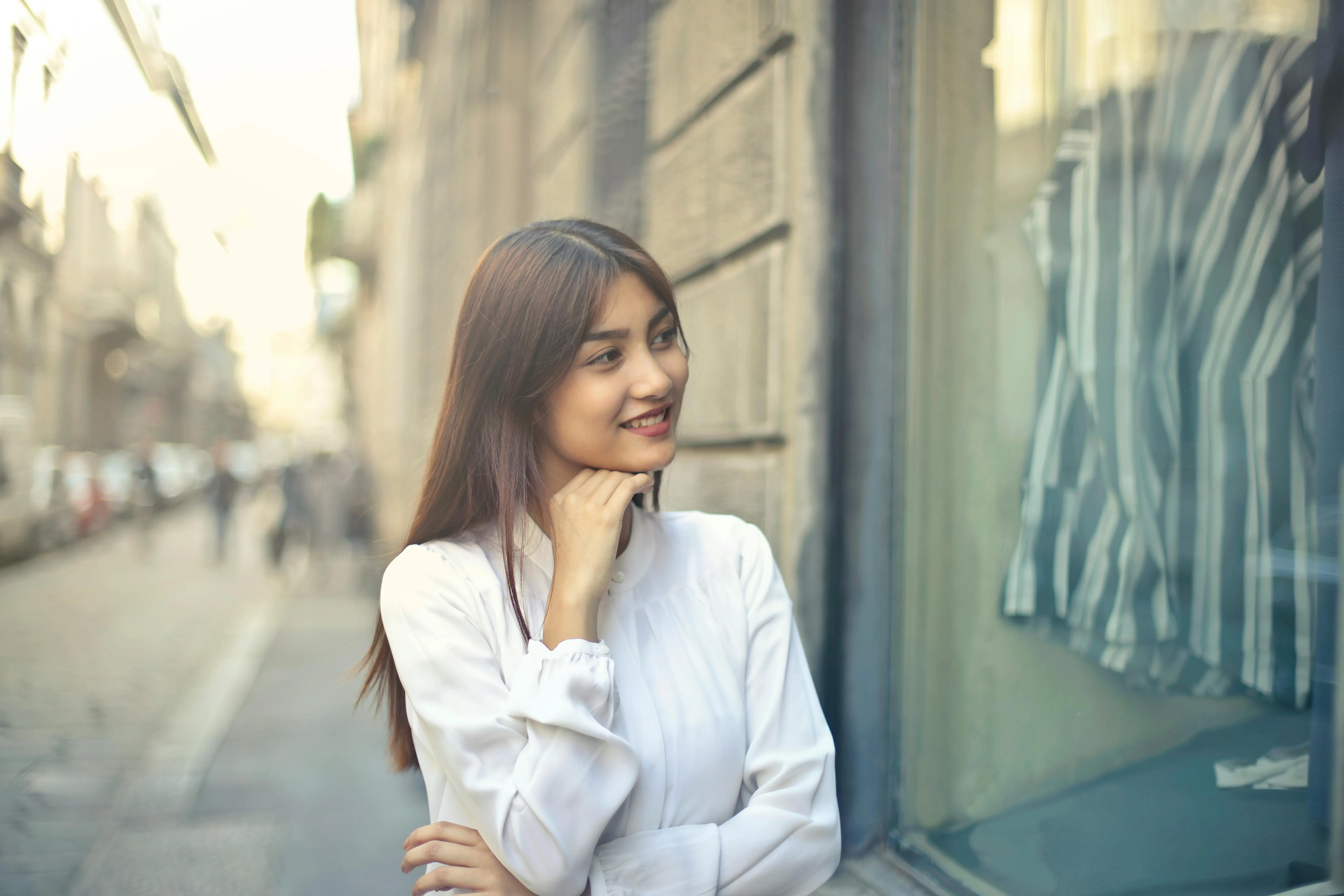Woman smiling looking in store window