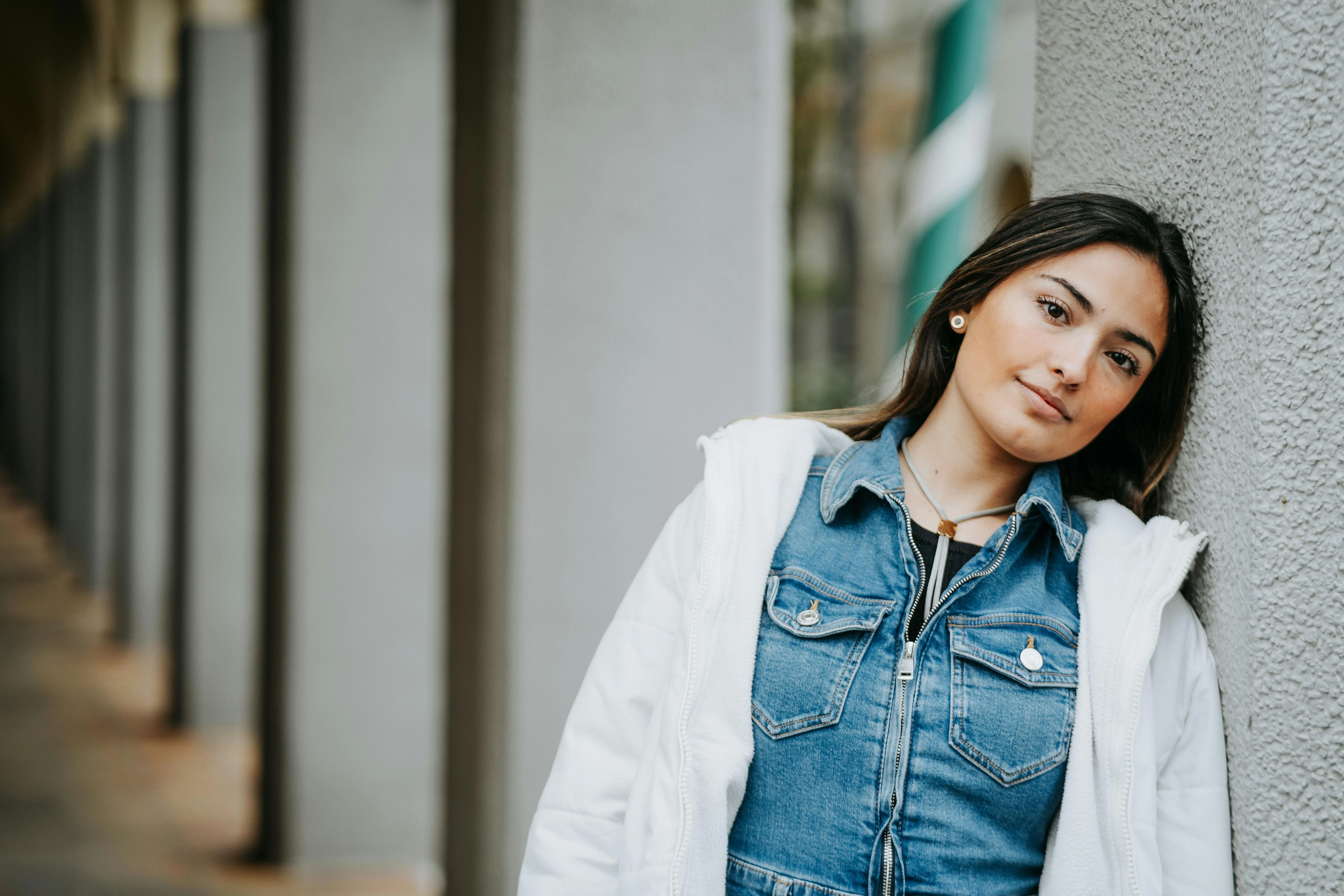 Woman leaning on building