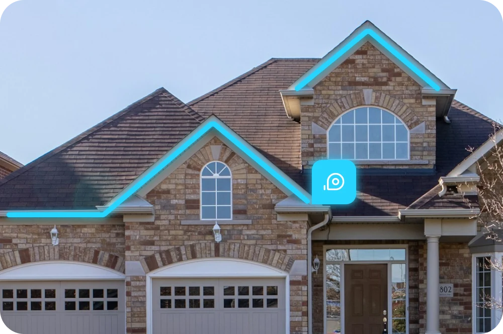 Brick two-story house with a brown roof featuring highlighted roof edges, two garage doors, multiple windows, and a front door with a columned porch.