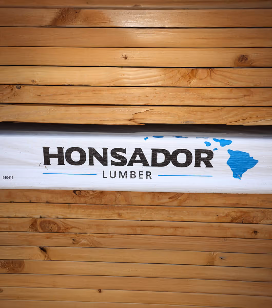 Stack of lumber with center boards wrapped in Honsador Lumber logo