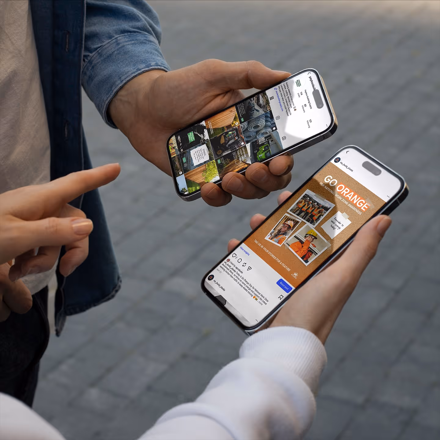 Two people holding smartphones displaying social media posts, one features construction workers with 'Go Orange' message.