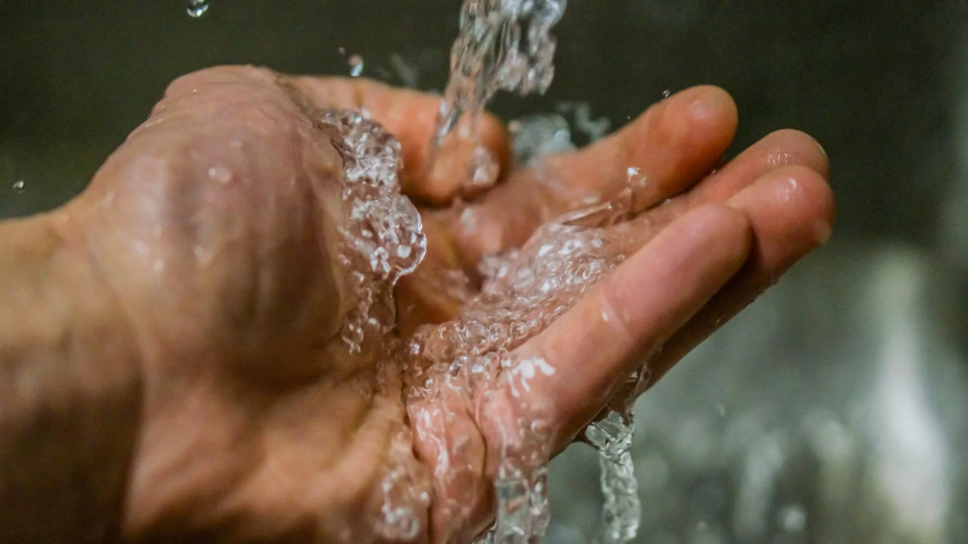 Clean water running over hand