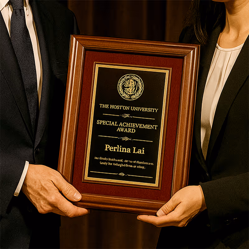 Two people in suits holding a placard award.
