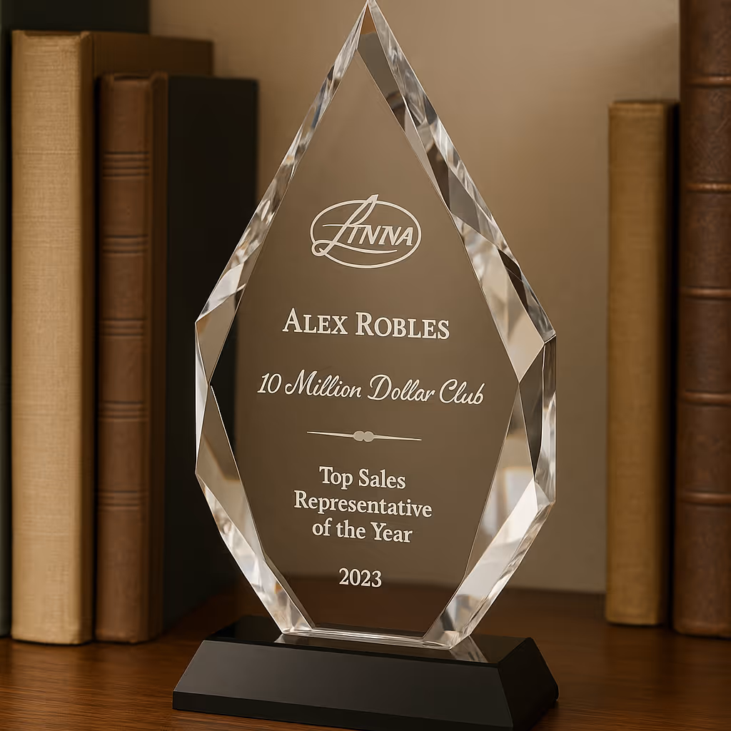 A crystal award for a top sales rep sitting on a bookshelf.