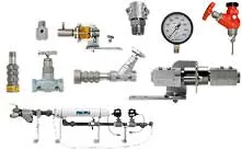 Various metal industrial valves, pressure gauge, and pipe fittings arranged on a white background.