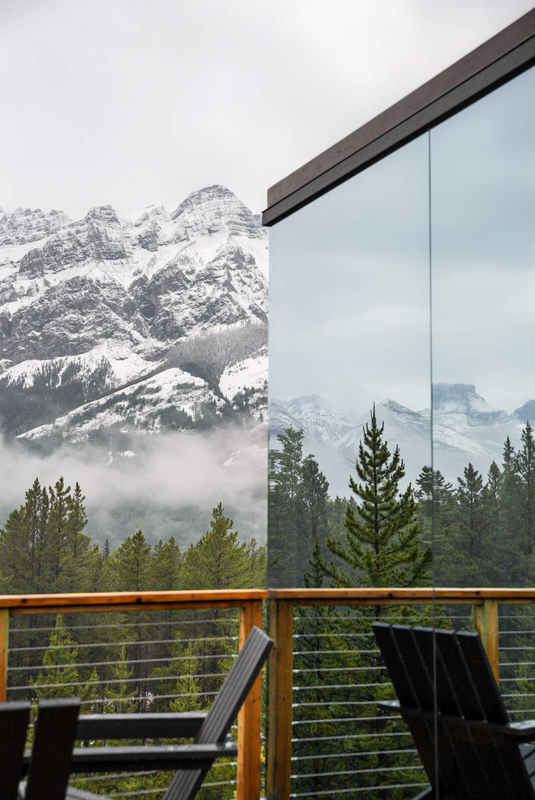 Outside of a the Skyglass reflecting mountains on the windows
