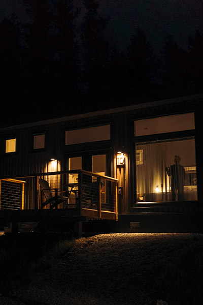 man standing in the window of a skybox at night