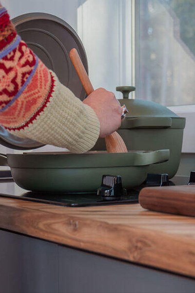 person cooking food in the kitchen of a cabin