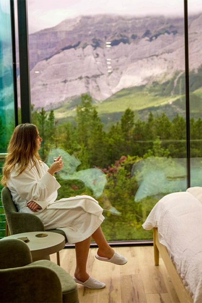 woman enjoying coffee while looking out the window