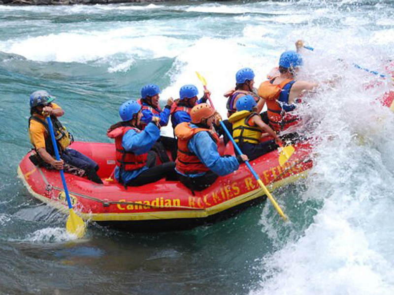 Group of people white water rafting