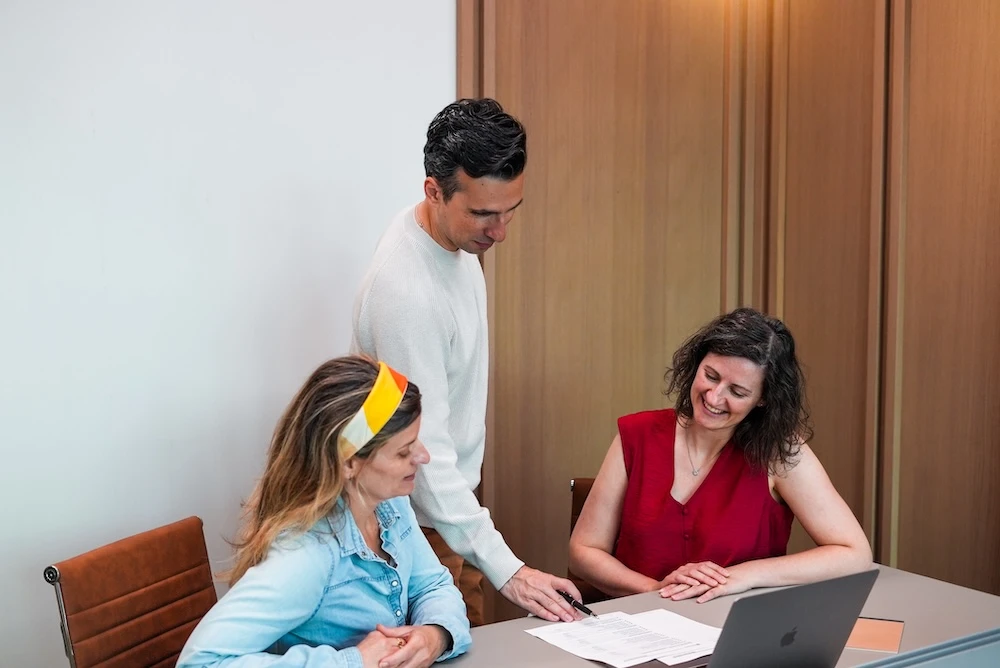 Professional working at a desk managing relocation planning and coordination tasks
