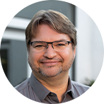 Profile photo of a man with glasses in business casual attire