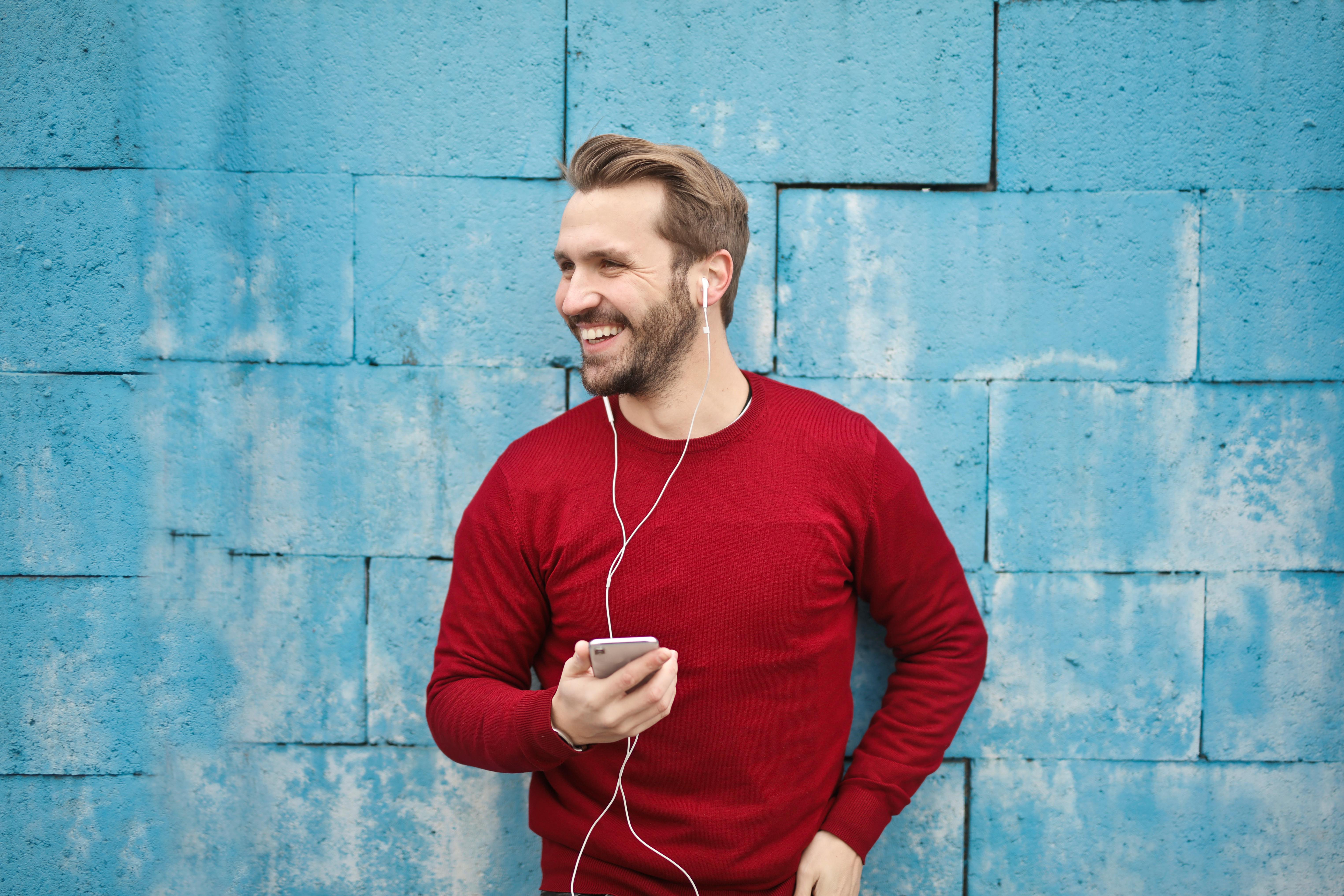 Man standing in front of blue wall